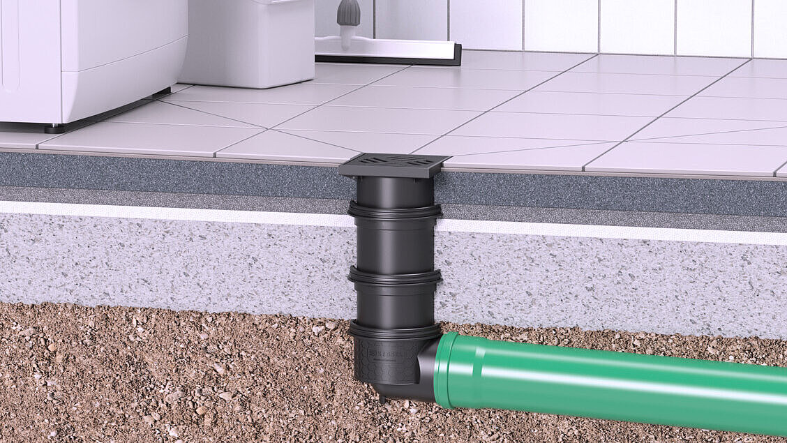 A basement drain that runs through the concrete floor and discharges into the ground.